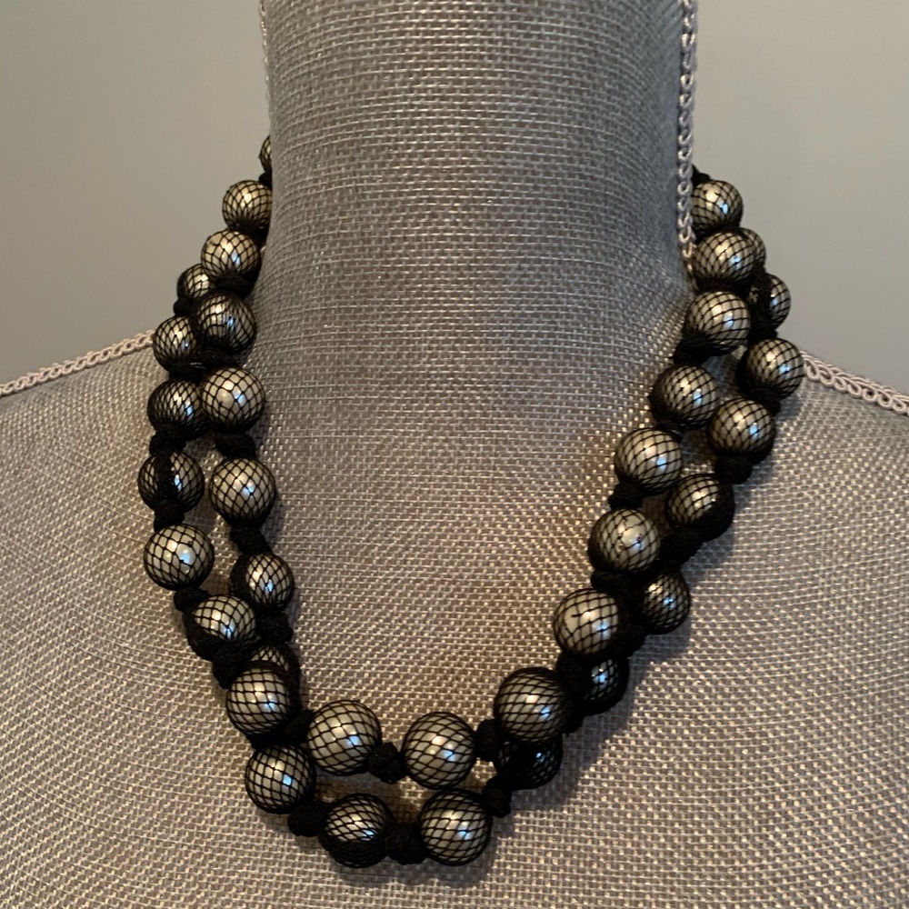 Black fishnet covered pearl necklace